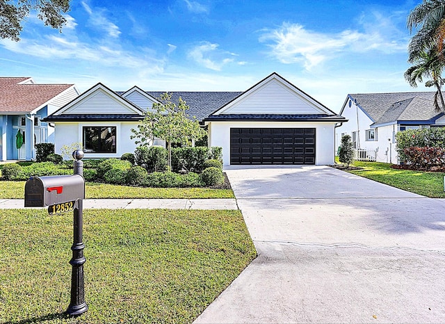 view of front of house with a front yard and a garage