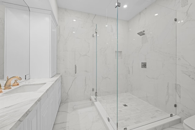 bathroom featuring vanity, a shower with shower door, and toilet