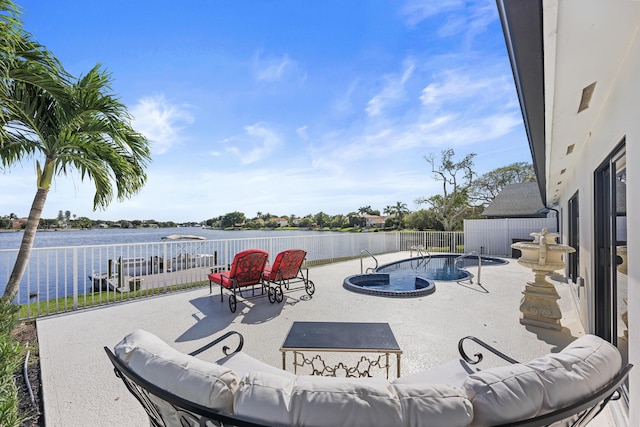 view of patio / terrace with a fenced in pool and a water view