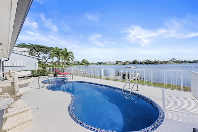 view of pool with a patio area and a water view