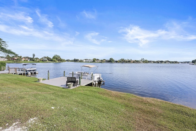 dock area with a water view and a lawn