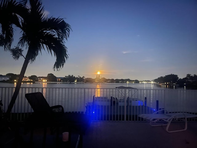 pool at dusk with a water view