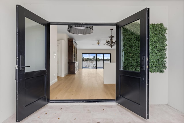 doorway with ceiling fan