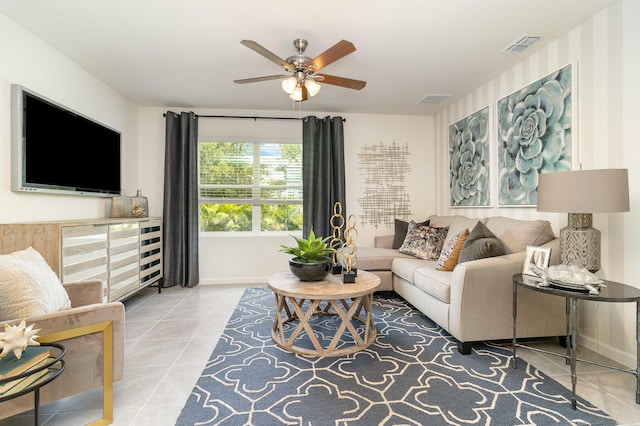 living room with ceiling fan and tile patterned flooring