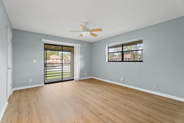 151 SW S River Dr Unit 203, Stuart, FL 34997 - spare room with light wood-style floors, ceiling fan, healthy amount of natural light, and a textured ceiling