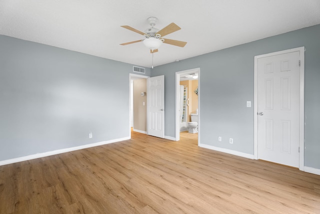 151 SW S River Dr Unit 203, Stuart, FL 34997 - unfurnished bedroom featuring light wood finished floors, ensuite bath, and a ceiling fan