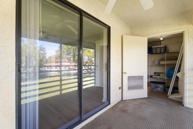151 SW S River Dr Unit 203, Stuart, FL 34997 - property entrance featuring stucco siding and a ceiling fan