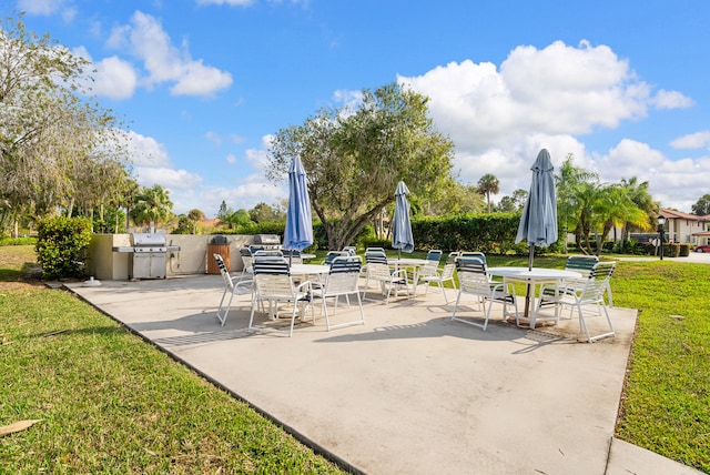 151 SW S River Dr Unit 203, Stuart, FL 34997 - view of patio / terrace featuring an outdoor kitchen and outdoor dining space