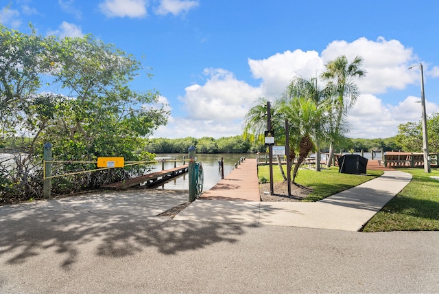 151 SW S River Dr Unit 203, Stuart, FL 34997 - dock area with a yard and a water view