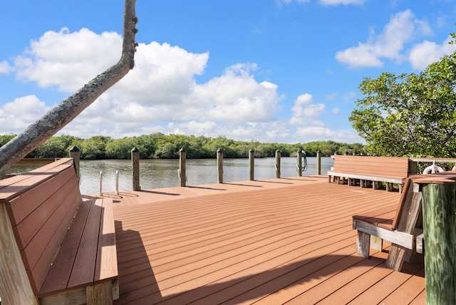 151 SW S River Dr Unit 203, Stuart, FL 34997 - wooden deck with a dock and a water view