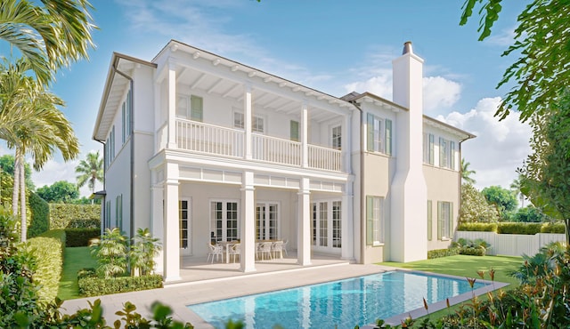 rear view of property with a fenced in pool, a yard, a patio area, french doors, and a balcony