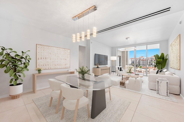 dining space featuring light tile patterned floors, an inviting chandelier, and expansive windows