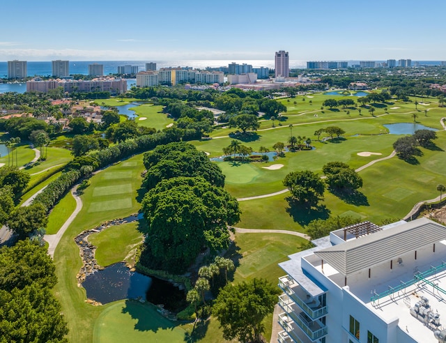 drone / aerial view featuring a water view, a view of city, and golf course view