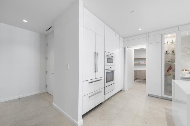 kitchen with white cabinets and white oven