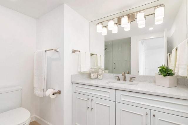 bathroom with vanity, an enclosed shower, and toilet