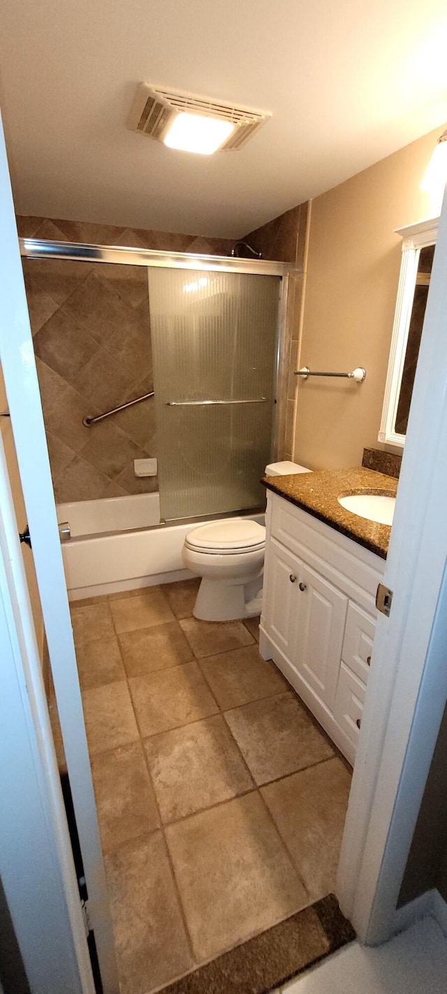 full bathroom featuring toilet, vanity, and combined bath / shower with glass door