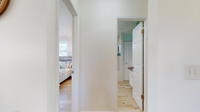 corridor with light wood-type flooring