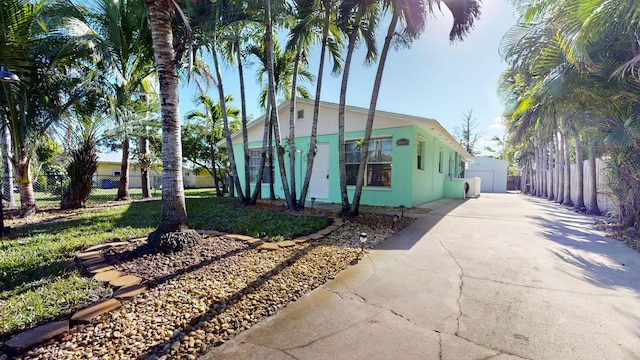 view of front of house with a garage and an outbuilding