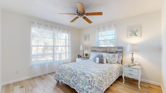 bedroom with hardwood / wood-style floors and ceiling fan