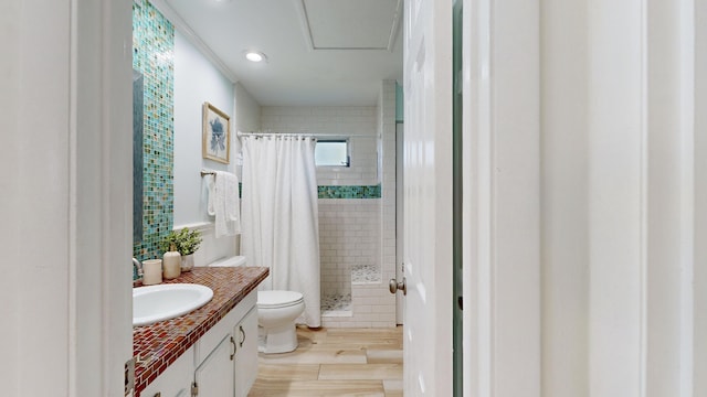 bathroom featuring hardwood / wood-style floors, vanity, curtained shower, and toilet