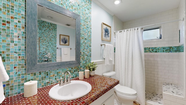 bathroom with vanity, a shower with curtain, toilet, ornamental molding, and tasteful backsplash