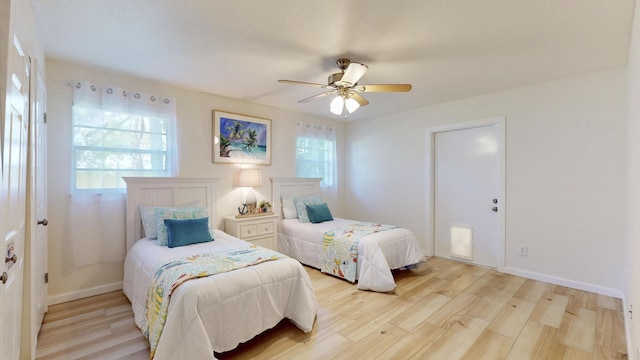 bedroom with light hardwood / wood-style floors and ceiling fan