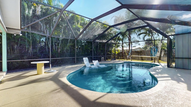 view of pool with a lanai and a patio