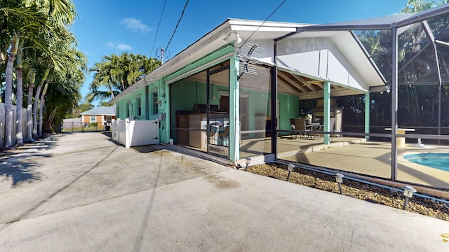 rear view of house featuring a lanai and a patio