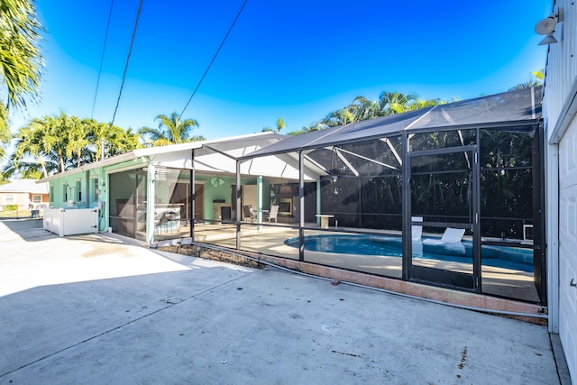 back of house with a lanai and a patio