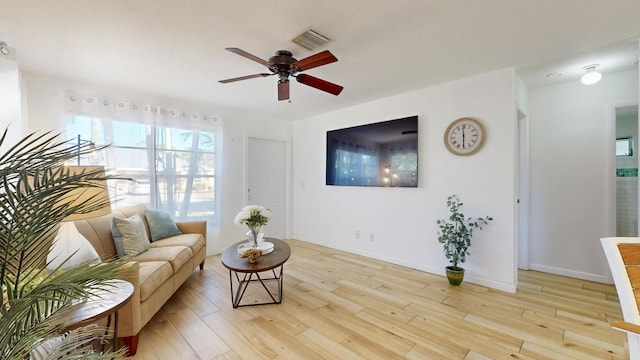 living room with light hardwood / wood-style flooring and ceiling fan