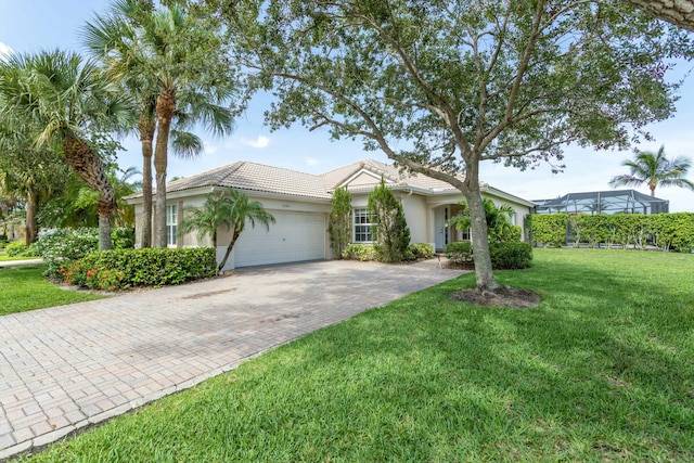 ranch-style home featuring decorative driveway, stucco siding, an attached garage, a tiled roof, and a front lawn