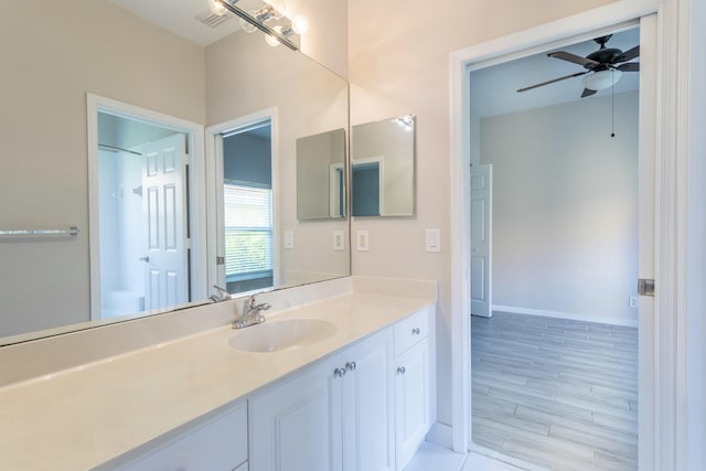 bathroom featuring ceiling fan, visible vents, vanity, and baseboards