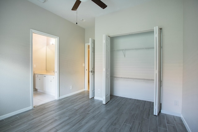 unfurnished bedroom with wood finish floors, a closet, ceiling fan, and baseboards