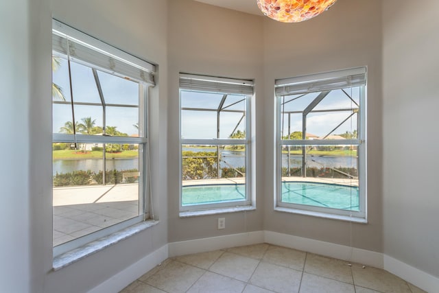 interior space with a water view and baseboards