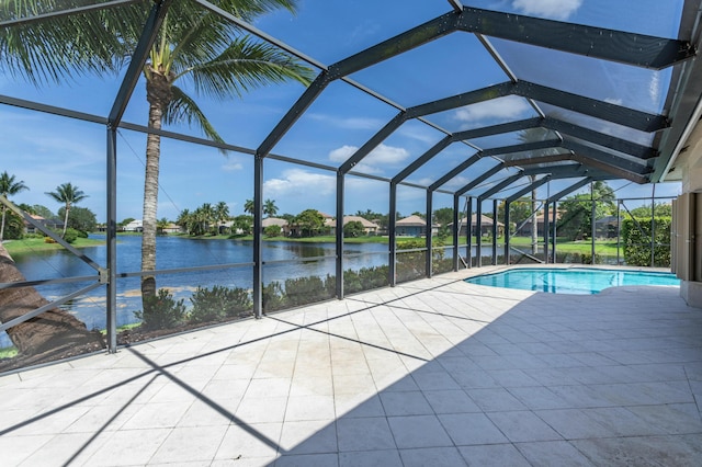 pool with a patio, a water view, and glass enclosure