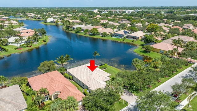 birds eye view of property with a water view and a residential view