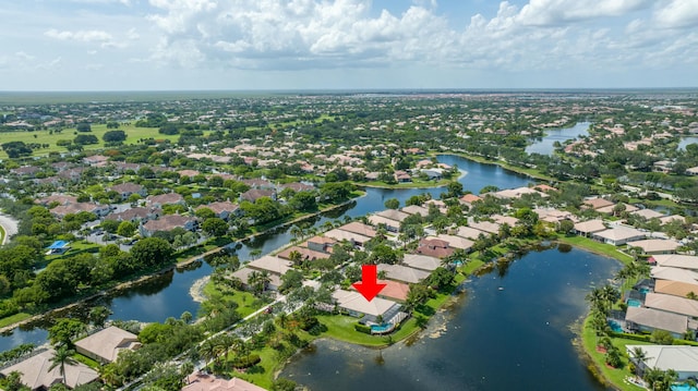 drone / aerial view featuring a residential view and a water view