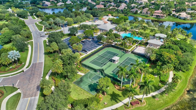 drone / aerial view featuring a residential view and a water view