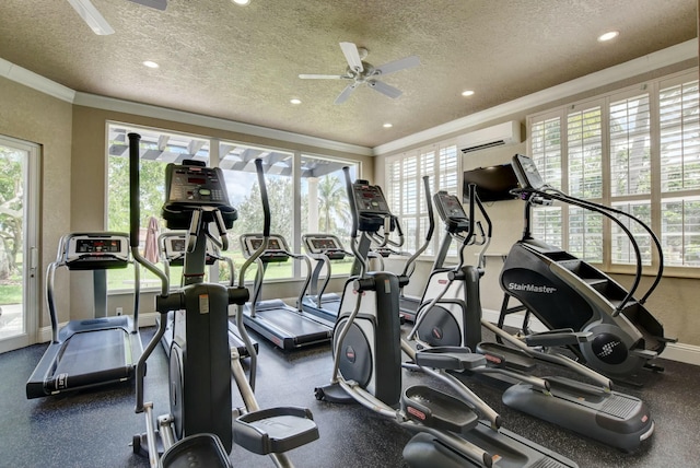 gym featuring a wealth of natural light, ornamental molding, and a textured ceiling