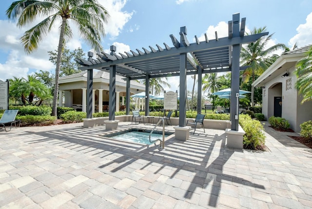 view of patio / terrace with a community hot tub and a pergola