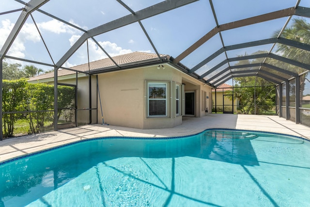 outdoor pool with a patio area and a lanai