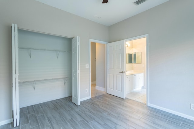 unfurnished bedroom with light wood-style floors, baseboards, visible vents, and a closet