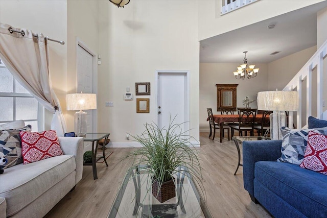 living room featuring light hardwood / wood-style flooring and a notable chandelier