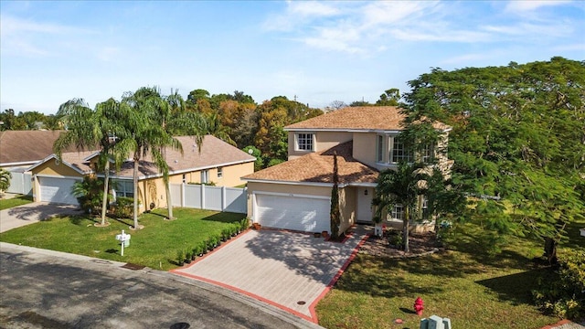 view of front of home with a front yard and a garage