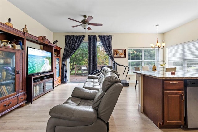 living room featuring light hardwood / wood-style floors and ceiling fan with notable chandelier