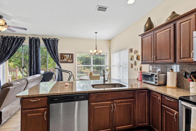 kitchen featuring light stone countertops, sink, stainless steel dishwasher, and dark brown cabinets