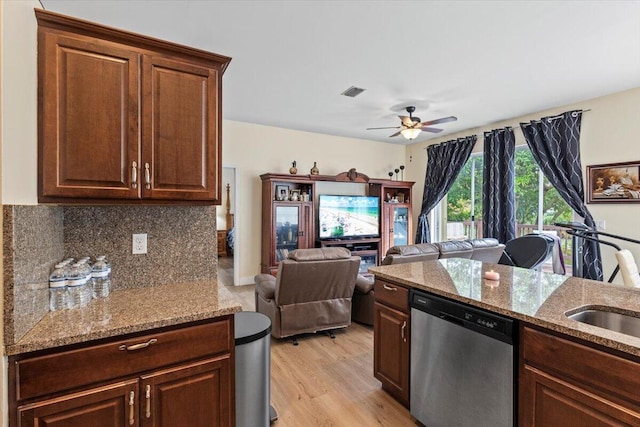 kitchen with dishwasher, ceiling fan, decorative backsplash, light stone countertops, and light hardwood / wood-style floors