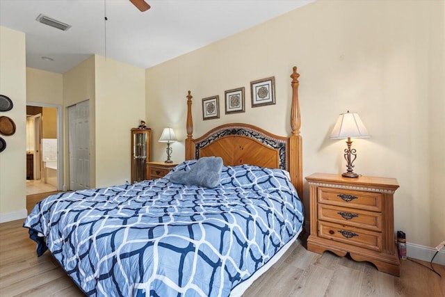 bedroom with ensuite bath, light hardwood / wood-style flooring, and ceiling fan