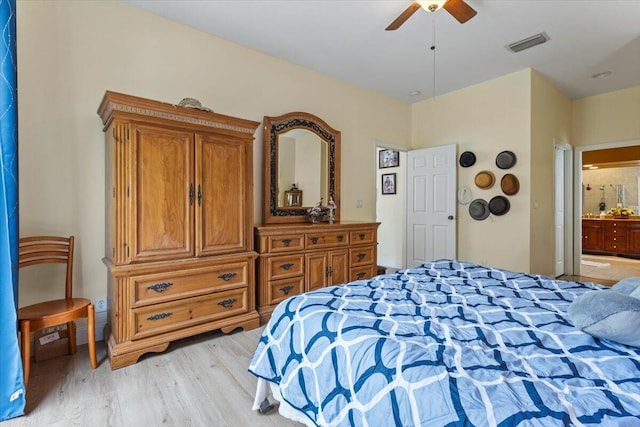 bedroom with ensuite bathroom, ceiling fan, and light hardwood / wood-style floors