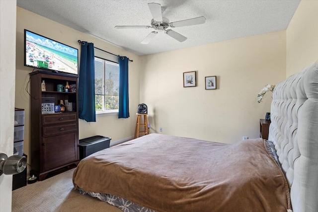 bedroom featuring carpet, a textured ceiling, and ceiling fan